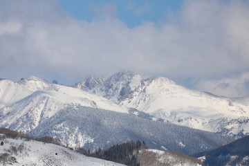 Fototapeta na wymiar Snowy Mountain in the Clouds