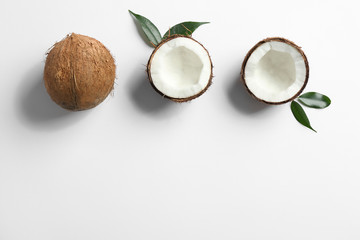 Fototapeta na wymiar Composition with coconuts on white background, top view