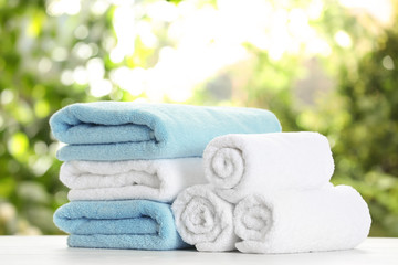 Obraz na płótnie Canvas Soft bath towels on table against blurred background