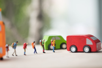Miniature people : traveler standing on road for hopping find passing car carrying to transfer station when in travel.