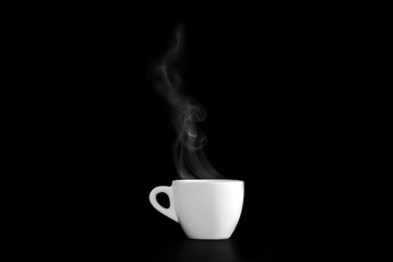Hot espresso coffee in white porcelain cup on black background