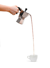 Pouring espresso from silver moka pot to porcelain cup
