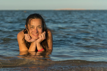 Beautiful, happy woman in the sea. Woman Enjoying Beach Holiday