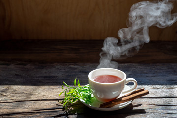 Hot tea cup in a glass on wood background.Hot drink . Copy space.