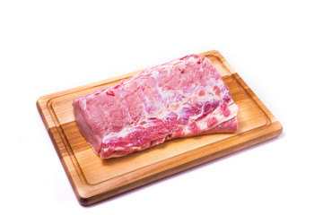 Raw pork meat on a wooden board