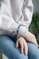 the girl on her arm has a bracelet of blue stones (kyanite), a bracelet of kyanite.