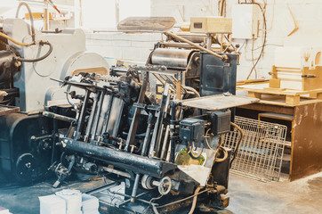 Old vintage printing machine for cutting cardboard in the printing house. Box, production.