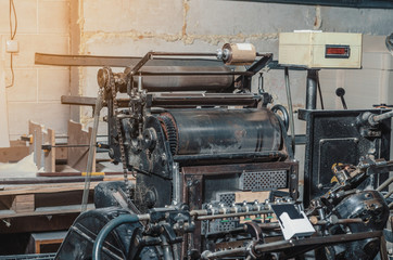 Vintage printing machine for carving in printing. Part of the old mechanism, regulators, gears.