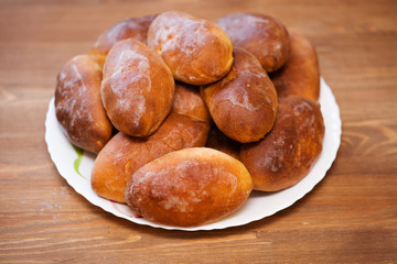 Appetizing fried pies lie on a plate.