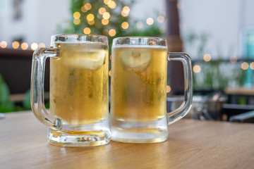 cold beer glass on a bar scene in the background