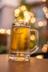 cold beer glass on a bar scene in the background