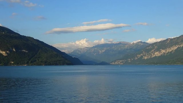 Timelapse view lake Thun (Thunersee) and mountains of Swiss Alps in city Spiez, Switzerland, Europe. Summer landscape, sunshine weather, blue sky and sunny day