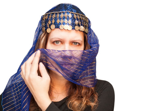 A woman with a serious, sad face with a paranja closes her face on a white background