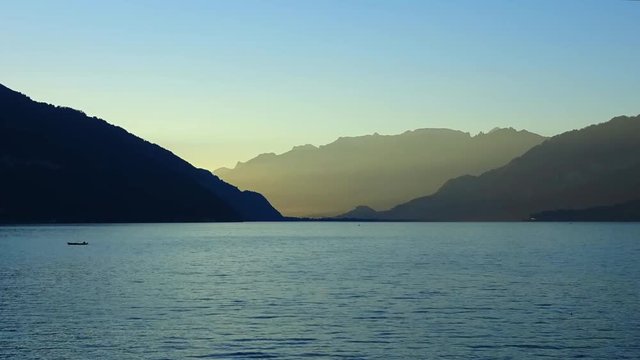 Timelapse view lake Thun (Thunersee) and mountains of Swiss Alps in city Spiez, Switzerland, Europe. Summer landscape, sunshine weather, blue sky and sunny day