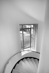 spiral staircase with window with garden view