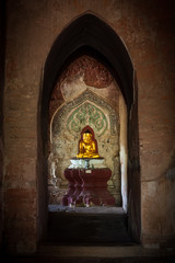Small golden buddha statue in a temple in Bagan, Myanmar