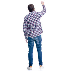 A man in jeans shirt standing showing on a white background. Isolation, back view