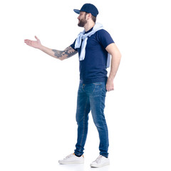 Man in jeans, t-shirt and cap smiling showing on white background isolation