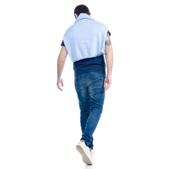 Obraz premium Man in jeans walking goes on white background isolation, back view