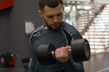 Man in the gym with kettlebells and weights.