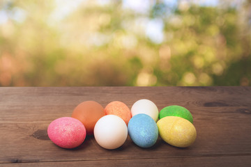 Easter eggs in basket on spring background