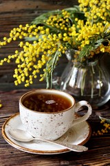 Spring Tea Party against the backdrop of a mimosa flower