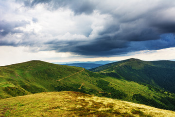 Summer in the Carpathian massif of Swidovets, located in Ukraine, with a lot of lakes, green pasture for sheep and horses, and wonderful, after a stormy sky with a rainbow.