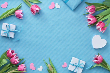 Springtime flat lay with giift boxes, pink tulips and decorative hearts, copy-space