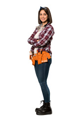 A full-length shot of a Young worker woman with arms crossed and looking forward over isolated white background