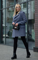 beautiful young blonde woman walking on the street.
