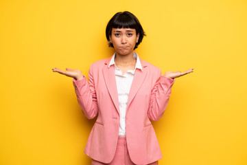 Modern woman with pink business suit unhappy and frustrated with something because not understand...