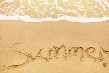 Summer text written on sandy beach and sea waves. Relaxing on tropical island. Summer vacation concept. Hello summer concept.