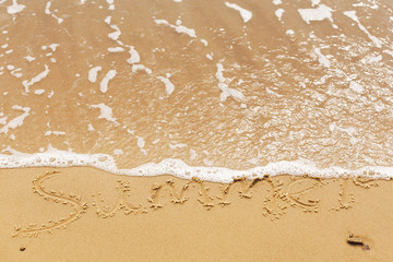 Hello summer concept. Summer text written on sandy beach and sea waves. Relaxing on tropical island. Summer vacation concept