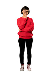 Fototapeta premium A full-length shot of a Short hair girl with red sweater with glasses and smiling over isolated white background