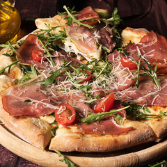pizza with prosciutto crudo, arugula and parmesan