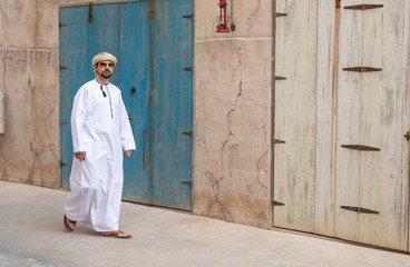 Arab Man walking in old Al Seef area of Dubai