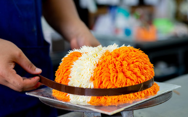 chef preparing cake in kitchen