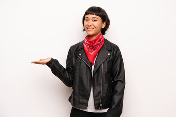 Woman with leather jacket and handkerchief holding copyspace imaginary on the palm to insert an ad