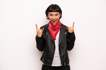 Woman with leather jacket and handkerchief making rock gesture