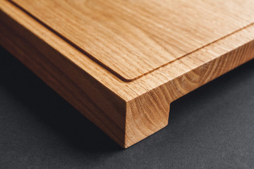 Walnut handmade wood cutting board on black wooden board