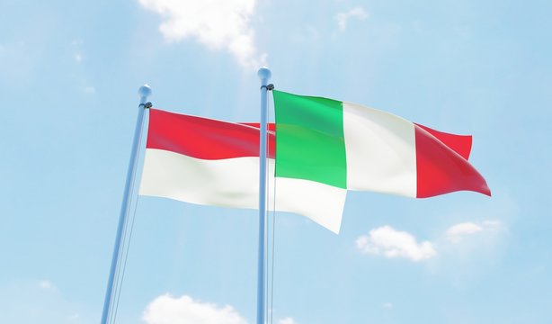 Italy and Indonesia, two flags waving against blue sky. 3d image