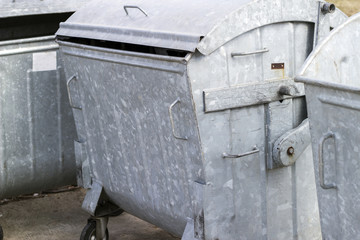 metal waste container with wheels.Three empty garbage bin. Garbage bin