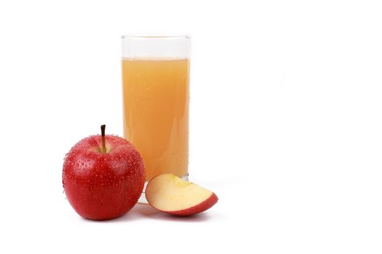 apple juice -  ​red apple with drops of water and a glass of naturally cloudy apple juice in front of white background