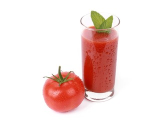 Tasty tomato juice and tomato's - glass with fresh tomato juice and a fresh tomato with drops of water isolated on white