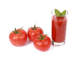 Tasty tomato juice and tomato's - glass with fresh tomato juice and a fresh tomato with drops of...
