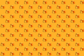 Oranges on bright colored yellow background. Repeating pattern, preparation for wallpaper citrus mood.