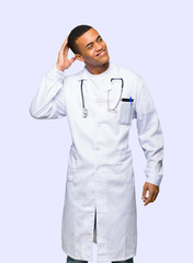 Young afro american man doctor thinking an idea while scratching head on isolated background