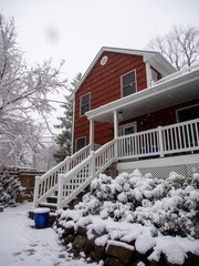 vertical view of red suburban house in the snow in winter