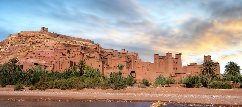 Ksar of Ait Ben Haddou (Ait Benhaddou) is a fortified city (ighrem) on the former caravan route between the Sahara and Marrakech in Morocco. UNESCO world heritage. Panorama at sunset desert