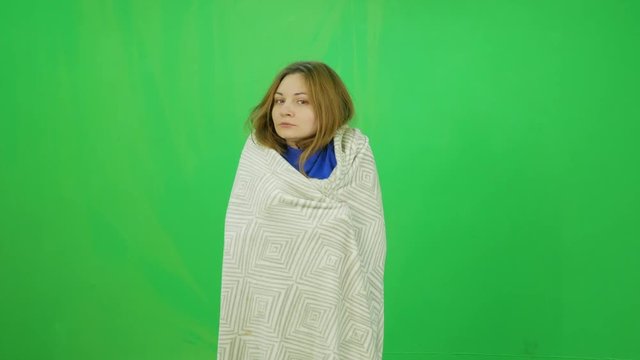 A young girl fell ill and was wrapped in a blanket green-screen shot